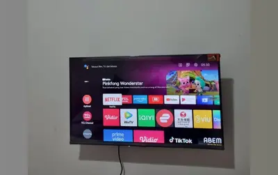 a flat screen tv hanging on a wall at RBE Hotel Kuta- 5 Min to Airport&Beach by Micky Studio in Ngurah Rai International Airport
