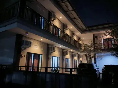 a building with a lot of windows at night at Room in Pesanggaran in Pesanggaran