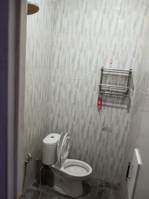 a bathroom with a white toilet in a stall at Room in Pesanggaran in Pesanggaran