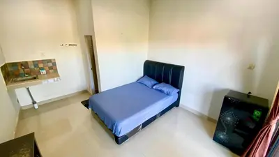 a small bedroom with a blue bed in a room at Room in Pesanggaran in Pesanggaran