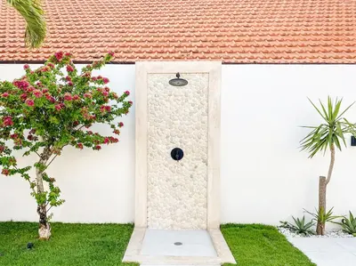 a door in the side of a house with a plant at Villa Balibiza 3 Kerobokan in Seminyak