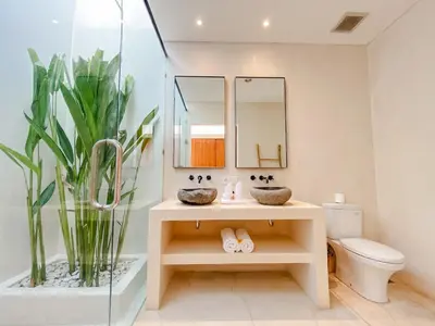 a bathroom with a sink and a toilet and mirrors at Villa Balibiza 3 Kerobokan in Seminyak