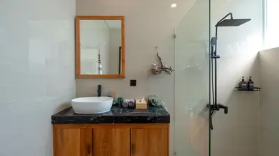 a bathroom with a sink and a glass shower at Villa Lange 3 by Villa Finder in Seminyak