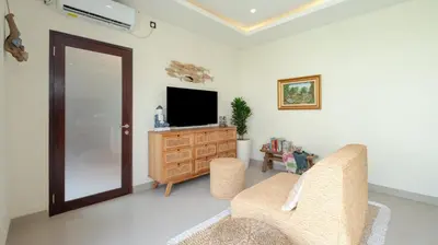 a living room with a television and a couch at Villa Lange 3 by Villa Finder in Seminyak
