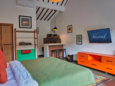 a bedroom with a bed and a tv on the wall at Mistral Studio Umalas in Canggu