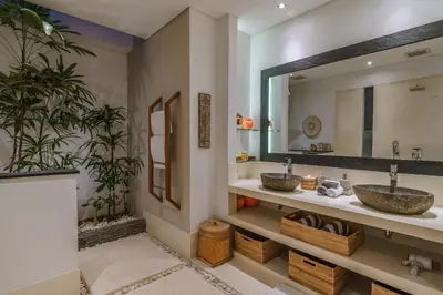 a bathroom with two sinks and a mirror at PROMO - 4 Bedroom Designer Villa 2 minutes to Berawa Beach & Finns in Canggu
