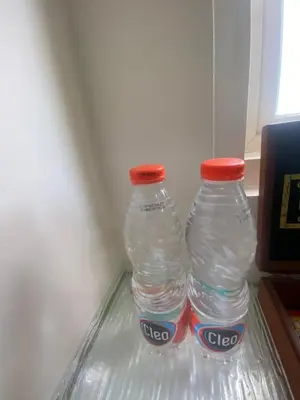 two bottles of water sitting in a refrigerator at AI Hotel Kuta - 15 Second to the Beach and 1 Minute to Airport by Micky Studio in Ngurah Rai International Airport