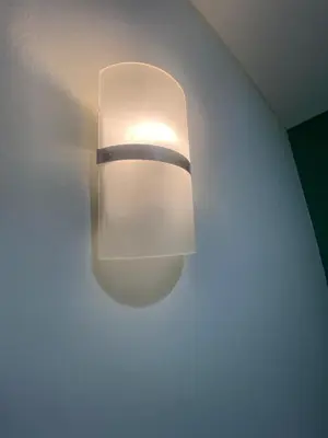 a light on a wall with a light on the ceiling at AI Hotel Kuta - 15 Second to the Beach and 1 Minute to Airport by Micky Studio in Ngurah Rai International Airport