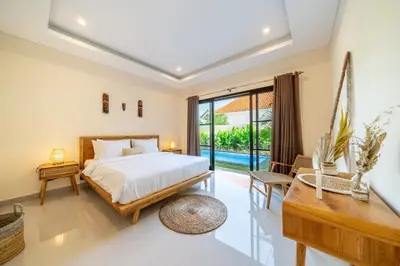 a bedroom with a bed and a pool at Alicia - Stylish 2BR Villa with Large Pool in Kerobokan