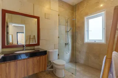a bathroom with a toilet and a sink and a shower at Villa Club Residence 8 by Maheswara in Canggu