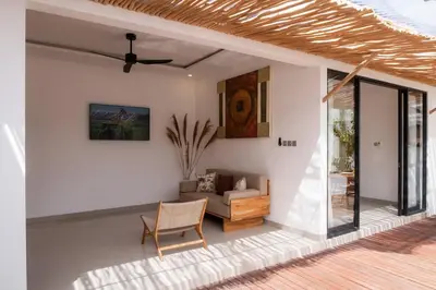 a living room with a couch and a ceiling fan at Villa Grace a 2BR Retreat with private pool in Seminyak