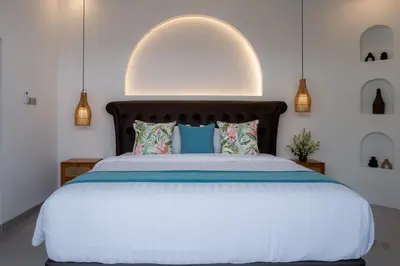 a bedroom with a large bed with a white bedspread at Villa Grace a 2BR Retreat with private pool in Seminyak