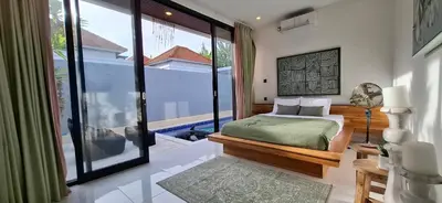 a bedroom with a bed and a large window at Modern Tropical 2 Bedroom Villa Ocean Nest in Canggu