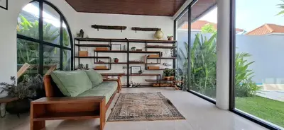 a living room with a couch on a balcony at Modern Tropical 2 Bedroom Villa Ocean Nest in Canggu