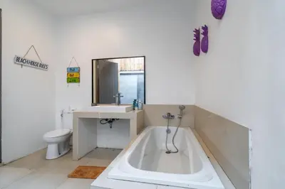 a bathroom with a tub and a sink and a toilet at Beautiful villas - Right by the beach - Seminyak in Badung