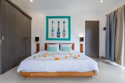 a bedroom with a large bed with oranges on it at Beautiful villas - Right by the beach - Seminyak in Badung