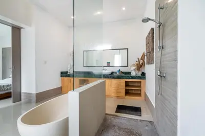 a bathroom with a tub and a sink at Beautiful villas - Right by the beach - Seminyak in Badung