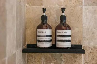 two bottles of wine sitting on a shelf at All-White Villa with Pool, Sauna, Firepit & Office in Jimbaran