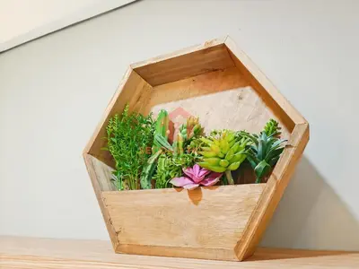 a wooden box filled with plants on a table at Lavaya Resort 1BR Nusa Dua with Pool, WiFi, Netflix by 2ndHome in Nusa Dua