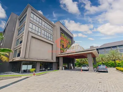 a building with a parking lot in front of it at Lavaya Resort 1BR Nusa Dua with Pool, WiFi, Netflix by 2ndHome in Nusa Dua