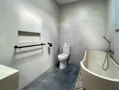 a bathroom with a toilet and a tub and a sink at Mango Villa Seminyak in Kerobokan