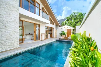 an external view of a villa with a swimming pool at Kuta Beach Villas by Great Bali Villas in Badung