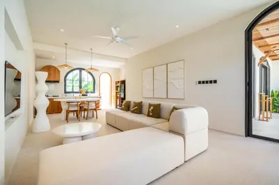 a living room with a white couch and a table at Kuta Beach Villas by Great Bali Villas in Badung