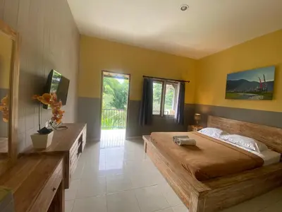 a large bedroom with a large bed and yellow walls at P Hotel Kuta-3minutes to the beach by Micky Studio in Legian