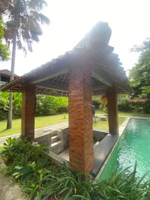 a pavilion next to a swimming pool in a garden at P Hotel Kuta-3minutes to the beach by Micky Studio in Legian