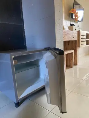 a refrigerator with its door open in a kitchen at P Hotel Kuta-3minutes to the beach by Micky Studio in Legian