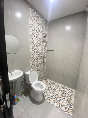 a bathroom with a toilet and a sink at SH Hotel Kuta- 20 Second to the Beach by Micky Studio in Legian