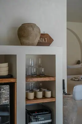 a shelf with bowls and vases on it at Villa Luuma 3 - Cozy Umalas Oasis, 1BR Private Villa in Canggu
