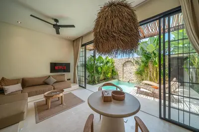 a living room with a couch and a table at Villa Luuma 3 - Cozy Umalas Oasis, 1BR Private Villa in Canggu