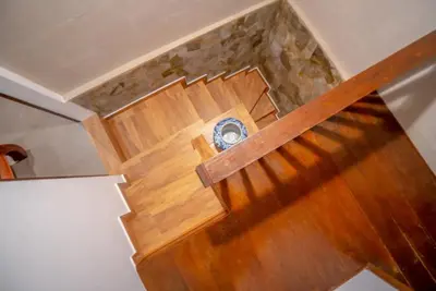 an overhead view of a wooden stairs with a clock at The Padma Room in Kerobokan