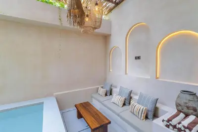 a living room with a couch and a table at Villa San Miguel by Pertama Management in Seminyak