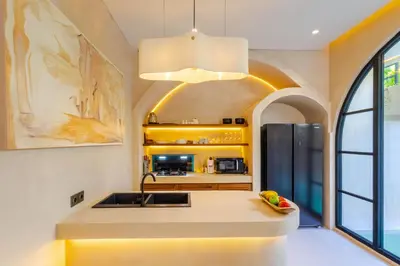 a kitchen with a sink and a refrigerator at Villa San Miguel by Pertama Management in Seminyak