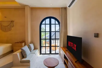 a living room with a tv and a window at Villa San Miguel by Pertama Management in Seminyak