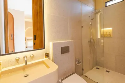 a bathroom with a sink and a toilet and a shower at Villa Santa Clara by Pertama Management in Seminyak