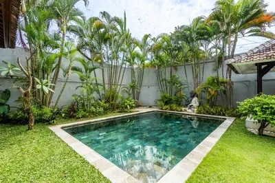a swimming pool in the yard of a house at The Hijau Damai Villa in Seminyak