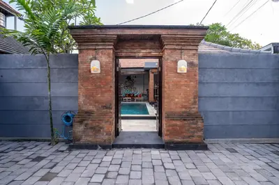 an entrance to a brick building with a swimming pool at Villa jepun berawa in Canggu