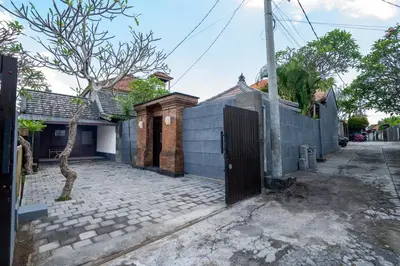a house with a gate on a street at Villa jepun berawa in Canggu