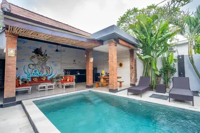 a villa with a swimming pool and a patio at Villa jepun berawa in Canggu