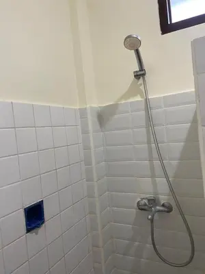 a shower with a shower head in a bathroom at SH Hotel - 20 Second to the Bach by Micky Studio R in Legian