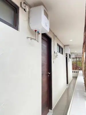 a hallway of a house with a door at SH Hotel - 20 Second to the Bach by Micky Studio R in Legian
