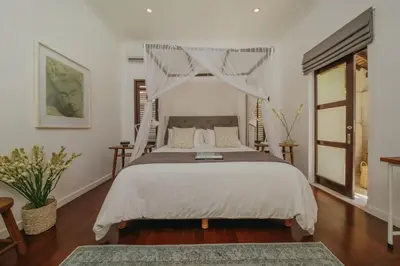 a bedroom with a bed with a canopy at Villa Delapan Seminyak in Seminyak
