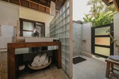 a bathroom with a sink and a mirror at Villa Delapan Seminyak in Seminyak