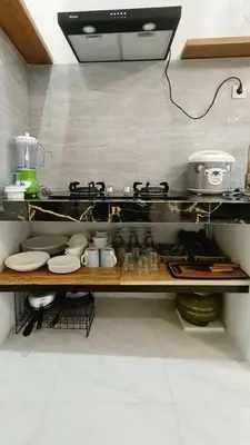 a kitchen with a counter with dishes and a stove at Villa TJ Subali 3 BR privatepool close to Seminyak in Seminyak