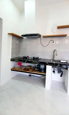 a kitchen counter with a stove and a sink at Villa TJ Subali 3 BR privatepool close to Seminyak in Seminyak