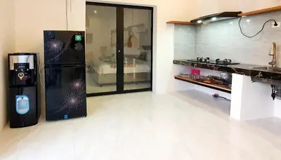 a kitchen with a black refrigerator in a room at Villa TJ Subali 3 BR privatepool close to Seminyak in Seminyak
