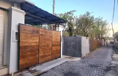 a wooden gate on the side of a house at Villa TJ Subali 3 BR privatepool close to Seminyak in Seminyak